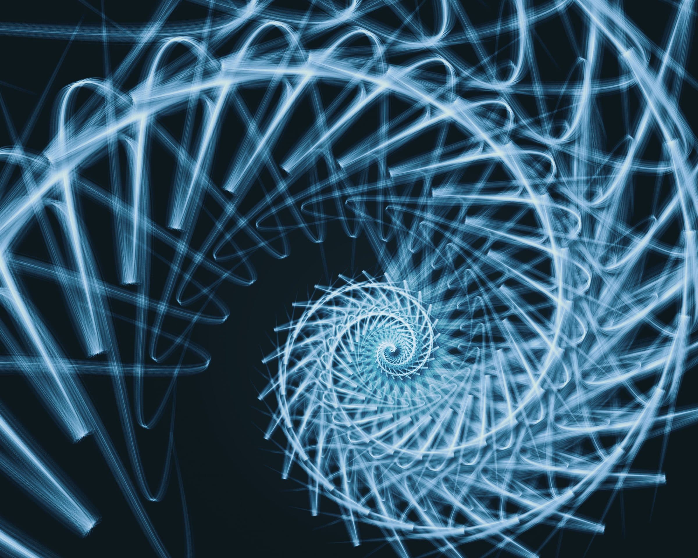 Trails of blue light turning in a spiral